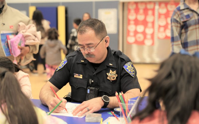 Officer coloring with kids at National Night Out